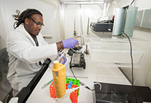 Christopher Benjamin, a Purdue graduate student in chemistry, prepares a Langmuir trough for lipid surface analysis in the laboratory